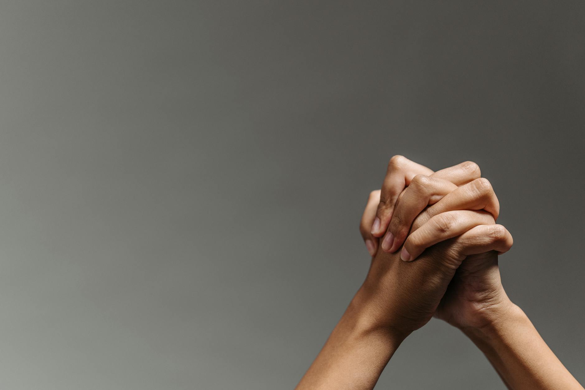 persons hand on gray background